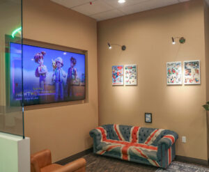 reception area with tv on wall and couch that looks like the British flag